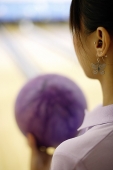Woman preparing to bowl, over the shoulder view - Asia Images Group