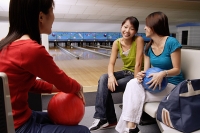 Women sitting in bowling alley - Asia Images Group