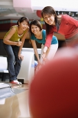 Three women at a bowling alley - Asia Images Group