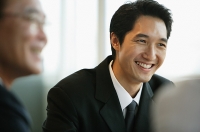 Businessman smiling, selective focus - Asia Images Group