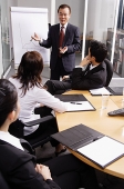 Businessman presenting to colleagues - Asia Images Group