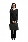 Businesswoman standing with briefcase, looking at camera - Asia Images Group