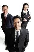 Executives standing together, smiling at camera - Asia Images Group
