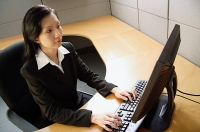 Businesswoman using computer in office - Asia Images Group