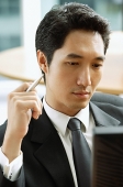 Businessman looking at computer monitor - Asia Images Group