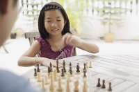 Father and daughter playing chess - Asia Images Group