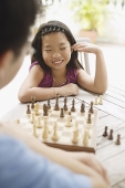 Father and daughter playing a game of chess - Asia Images Group