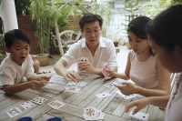 Family of four playing cards - Asia Images Group