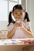 Girl holding glass of milk - Asia Images Group