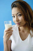 Woman holding a glass of milk - Asia Images Group