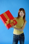 Woman carrying gift box - Asia Images Group