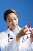 Female doctor preparing syringe - Asia Images Group