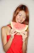 Woman holding a slice of watermelon - Asia Images Group