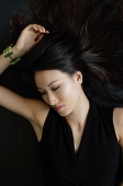 Woman lying on floor, looking away - Asia Images Group