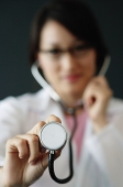 Female doctor using stethoscope, selective focus - Asia Images Group