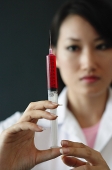 Female doctor holding syringe - Asia Images Group