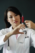 Doctor preparing syringe - Asia Images Group