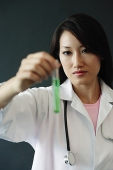 Doctor holding test tube - Asia Images Group