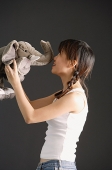 Young woman kissing stuffed toy elephant - Asia Images Group