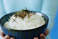 Woman holding bowl of rice - Asia Images Group