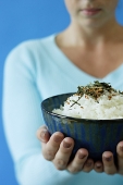 Woman holding bowl of rice, selective focus - Asia Images Group