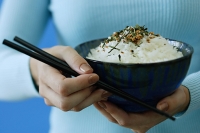 Woman holding bowl of rice and chopsticks - Asia Images Group