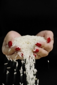 Woman holding rice in cupped hands - Asia Images Group