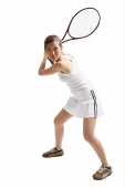 Young woman holding tennis racket, waiting for ball - Asia Images Group