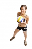 Young woman holding volleyball, smiling at camera - Asia Images Group