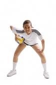 Young woman bending and holding volleyball - Asia Images Group