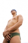 Young man with swim cap and goggles, hands clasped - Asia Images Group