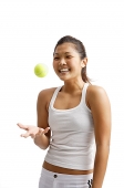 Young woman tossing tennis ball - Asia Images Group