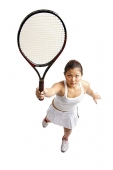 Young woman holding tennis racket, preparing to hit ball - Asia Images Group