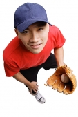 Young man wearing baseball glove and holding ball, high angle view - Asia Images Group