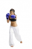 Female boxer, wearing boxing gloves, facing camera - Asia Images Group