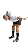 Young man in soccer uniform, balancing ball between his shoulder - Asia Images Group