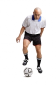 Young man playing with soccer ball - Asia Images Group