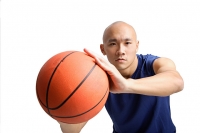 Young man holding basketball, towards camera - Asia Images Group