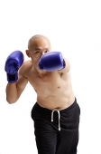 Young man wearing boxing gloves - Asia Images Group