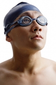 Young man with swimming cap and goggles, head shot - Asia Images Group