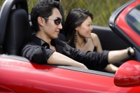 Couple in convertible sports car - Asia Images Group