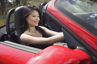 Woman driving red sports car - Asia Images Group