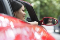 Woman in red sports car - Asia Images Group