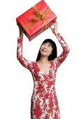 Woman looking at gift wrapped box - Asia Images Group
