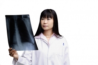Doctor looking at X-ray - Asia Images Group