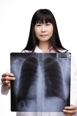 Doctor holding X-ray, looking at camera - Asia Images Group