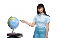 Woman pointing at globe - Asia Images Group
