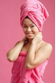 Woman wrapped in a pink towel, wearing pink turban - Asia Images Group
