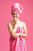 Woman wrapped in a pink towel - Asia Images Group