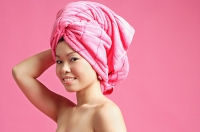 Woman with pink towel wrapped around her head - Asia Images Group